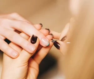 woman painting french tip