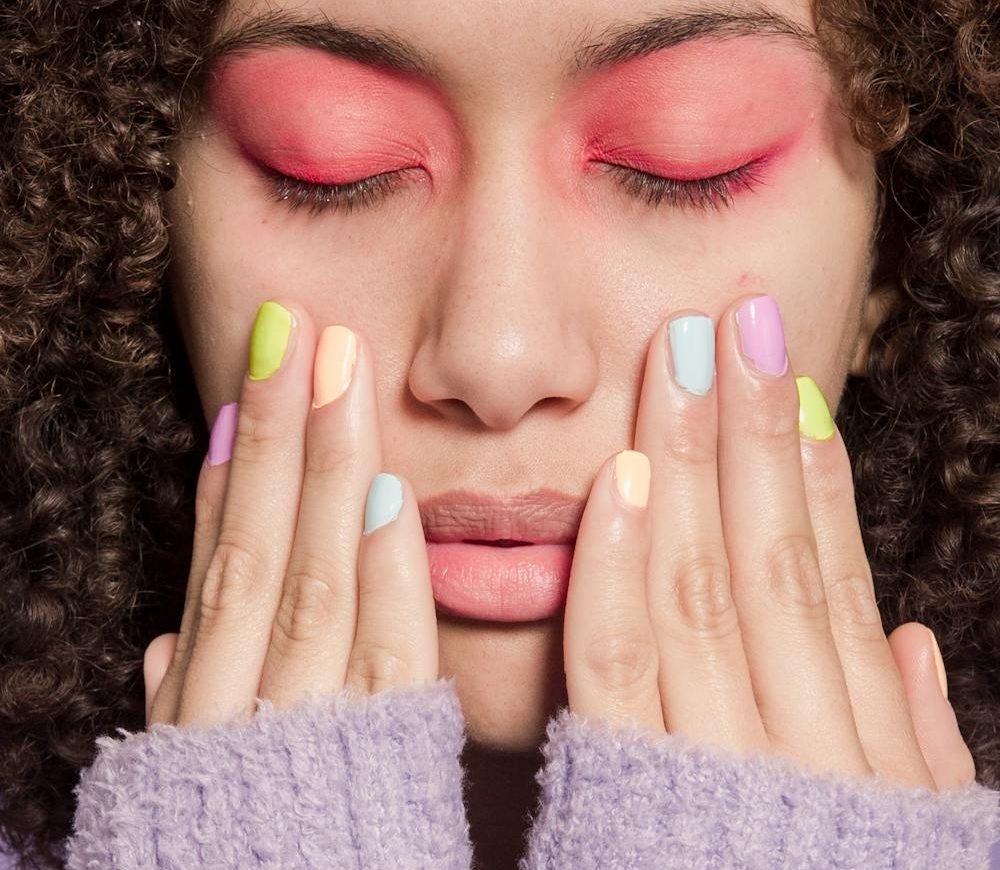 Woman with pastel nails and makeup