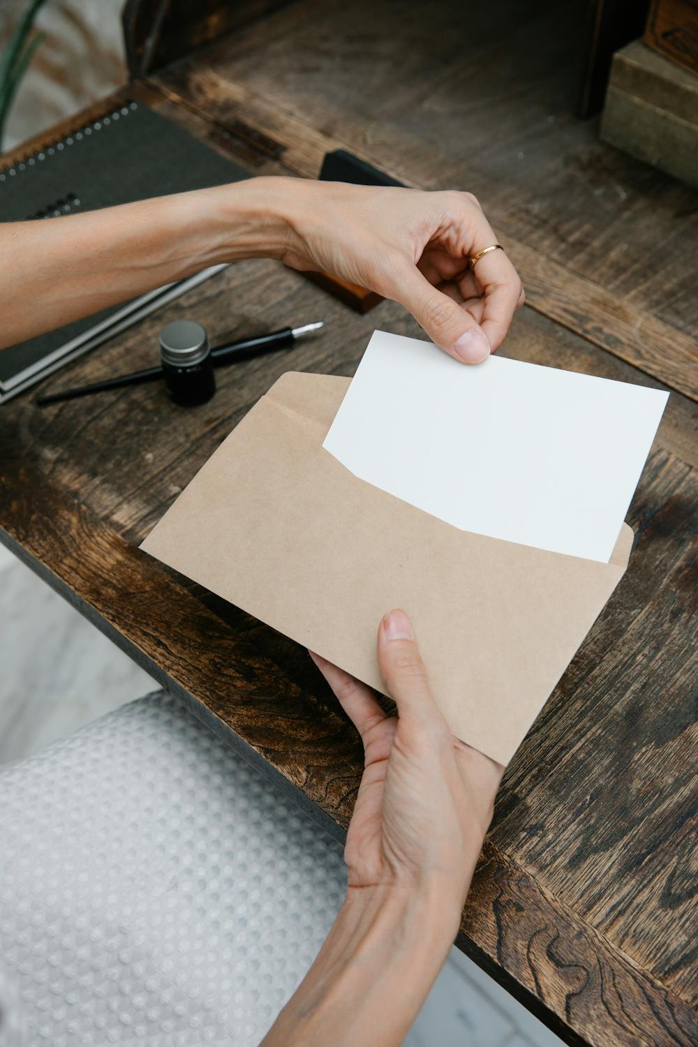 Woman putting letter in envelope