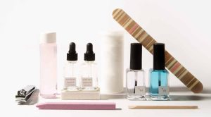 sundays studio mk.01 manicure kit tool (cuticle oil and serums, nail polish remover and base coat, cotton rounds, nail file, wooden stick and nail clipper) in front of a white background