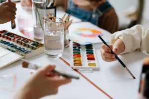 zoom in of children painting with water colors