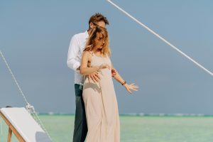 couple dancing in front of chaise longue on the beach