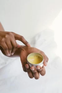 woman applying hand cream with clean, bare nails