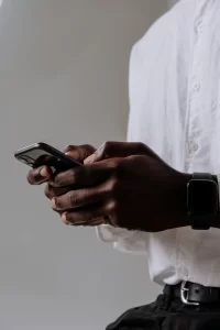 man typing on his phone