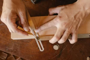 man drawing on wood