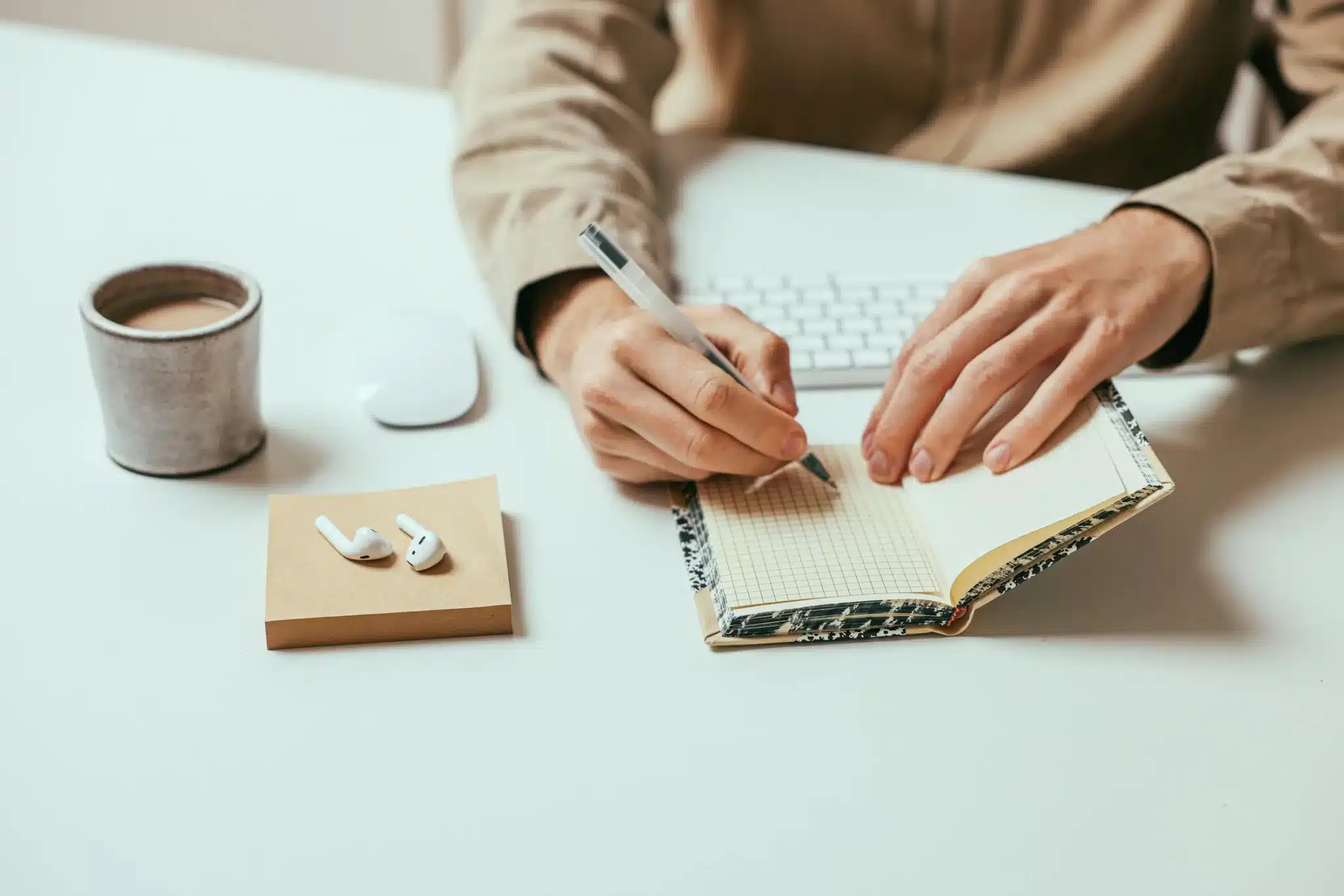man writing in a journal