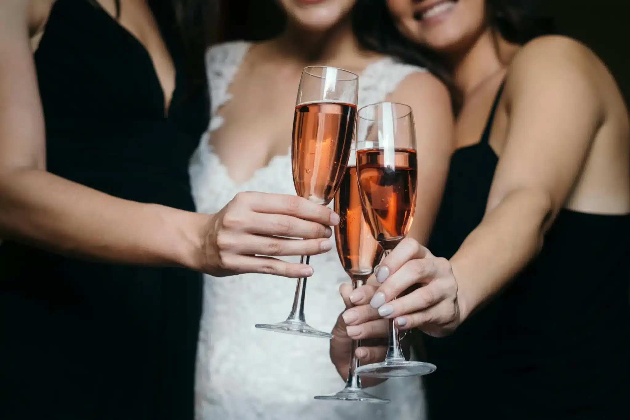 women cheers-ing champagne with a bride