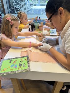 Two girls getting their nails painted at sundays studio nail salon in NYC.