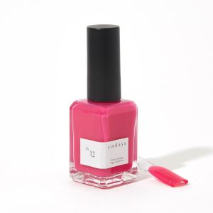 A bottle of sundays No.12 berry pink nail polish in front of a white background.