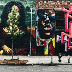 Street view of mural artwork on a building façade.