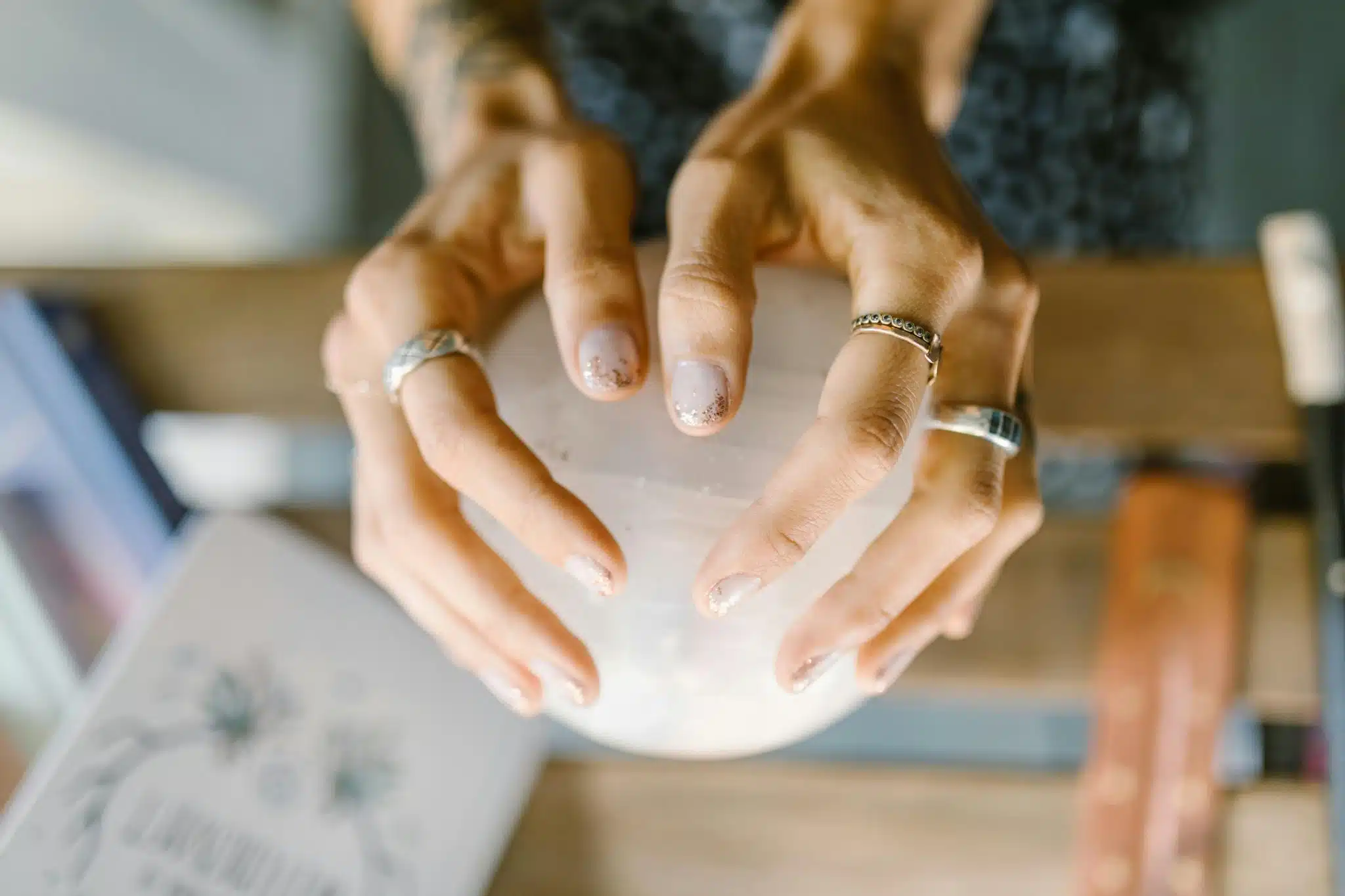 Woman holding a spherical pink crystal