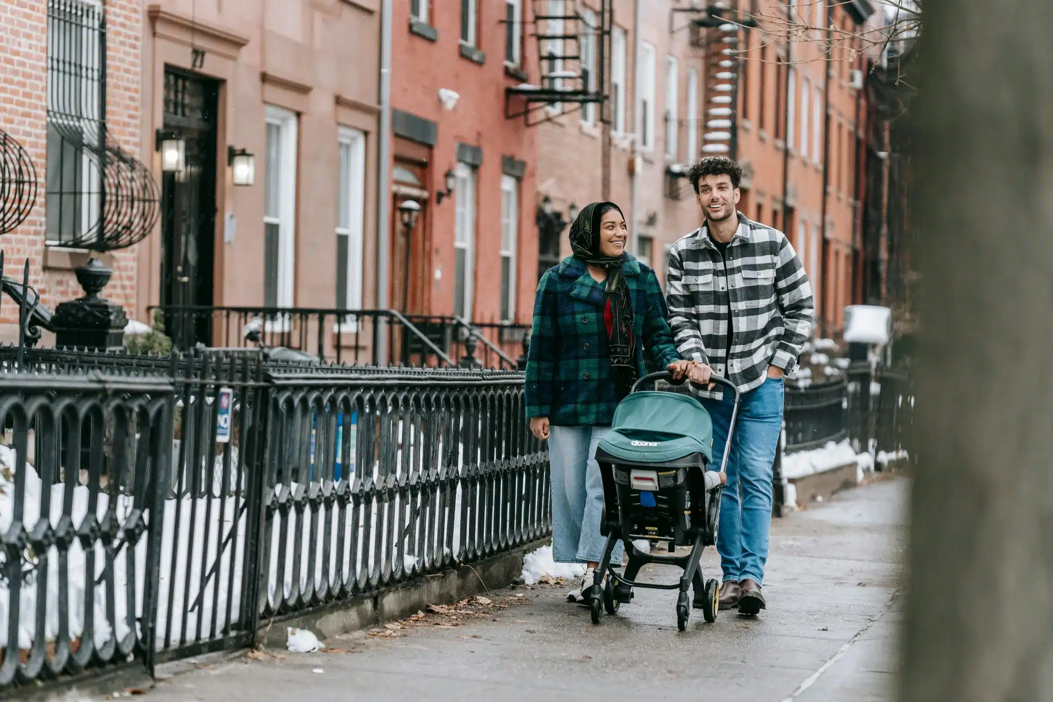 Family with stroller walking on the street