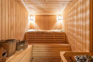 inside of a large wood paneled sauna with warm lighting