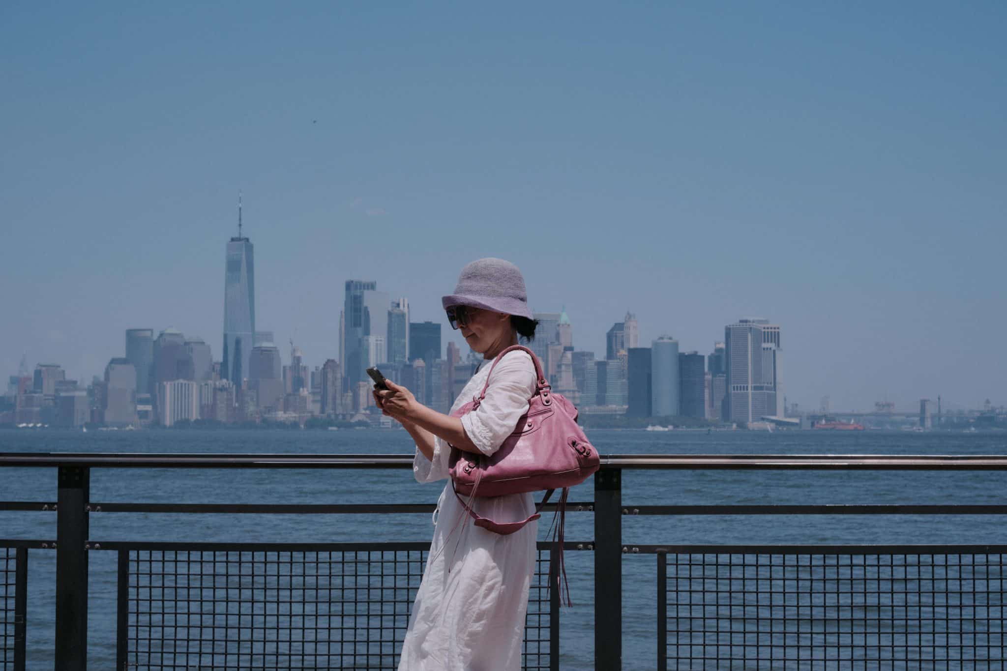 woman by the water front overlooking the nyc skyline