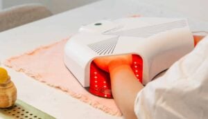 Hands in red light therapy hand mask